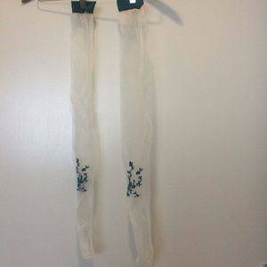 White thigh highs with blue floral pattern.